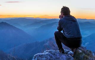 Man Looking Out Over Mountain Range